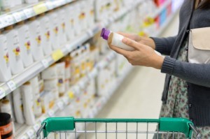 ady-looking-at-shampoo-in-grocery-store-